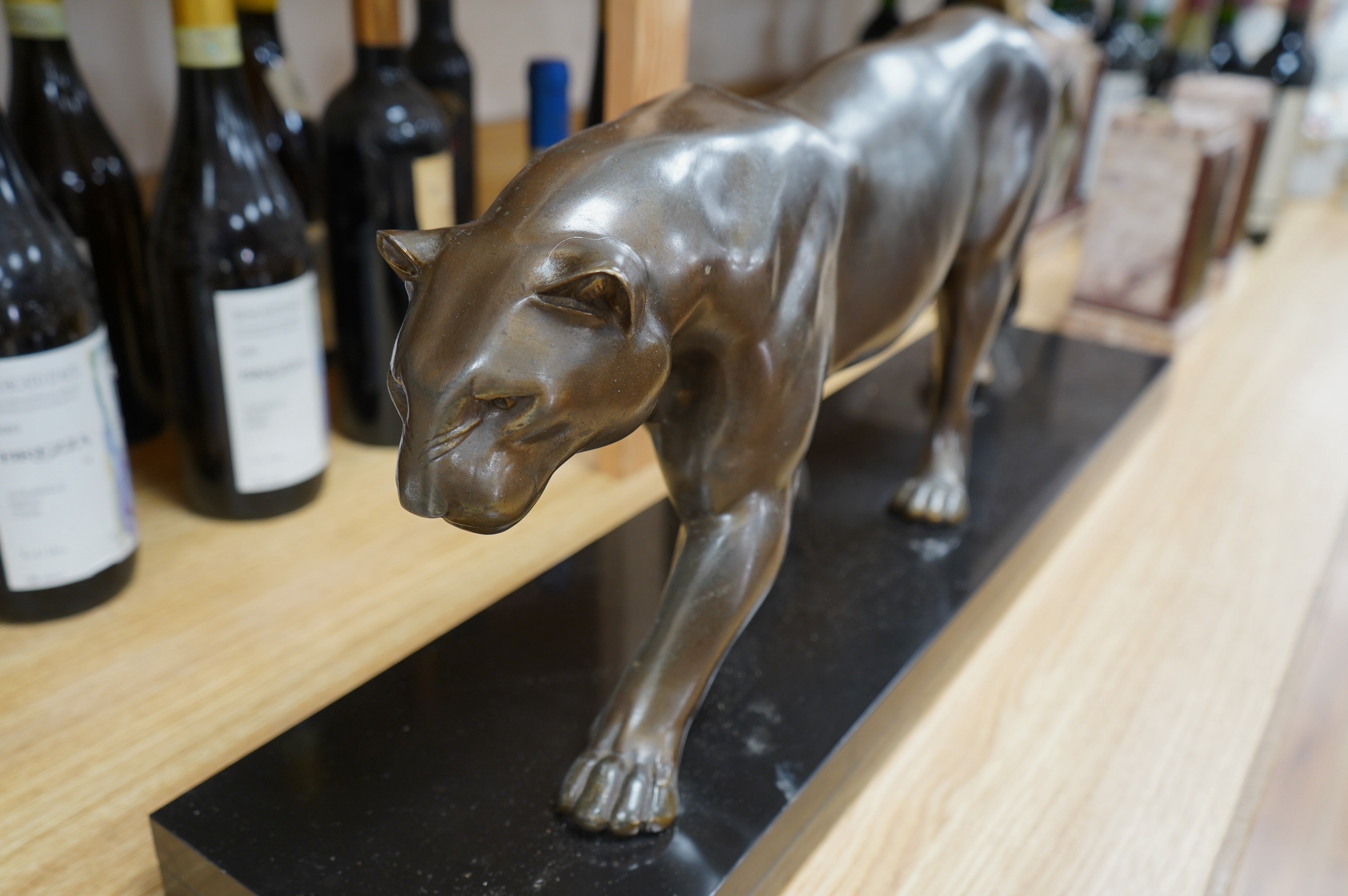 A large French Art Deco bronzed spelter panther, on black marble plinth, 71cm wide at base, 30cm high. Condition - good